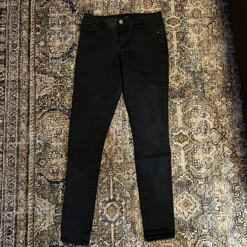 Poured in blue black skinny jeans